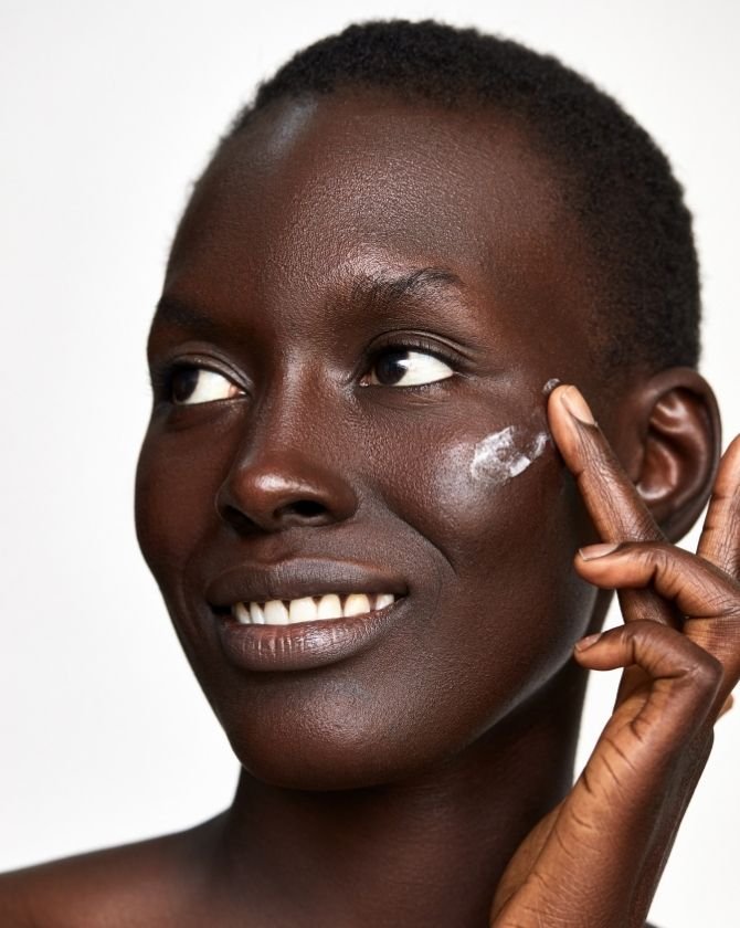 femme qui applique un crème sur son visage